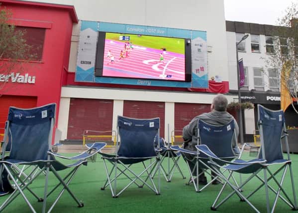Watching the fastest paralympian in the world, Jason Smyth, take gold and break his own world record in the 100m, on the big screen in Derry back in 2012. Picture Margaret McLaughlin Â©
