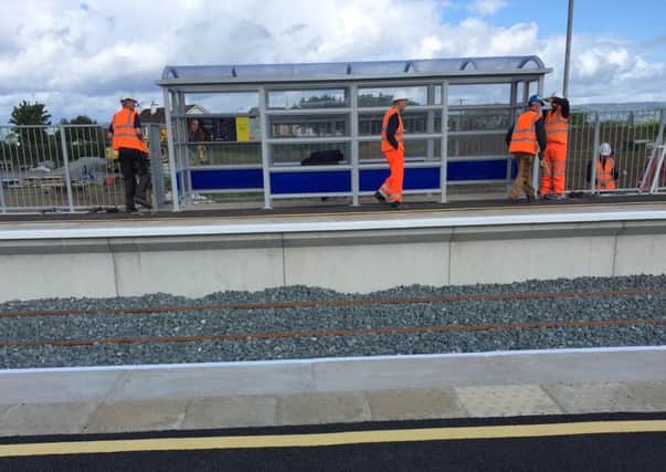 Workmen at the new and improved rail shelter at Bellarena.