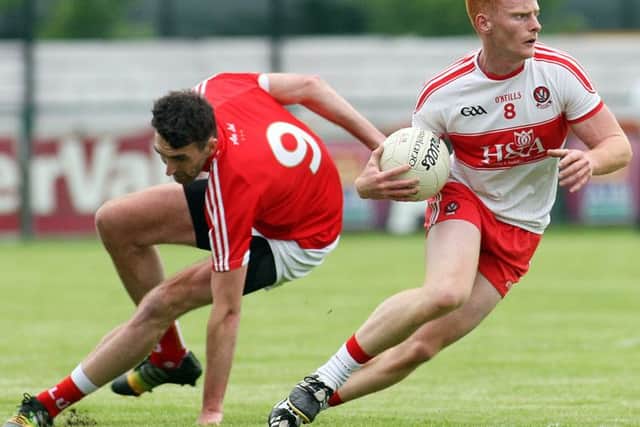 Derry's Conor McAtamney gets away from Louth's James Califf at Owenbeg on Saturday.

(Photo Lorcan Doherty / Presseye.com)