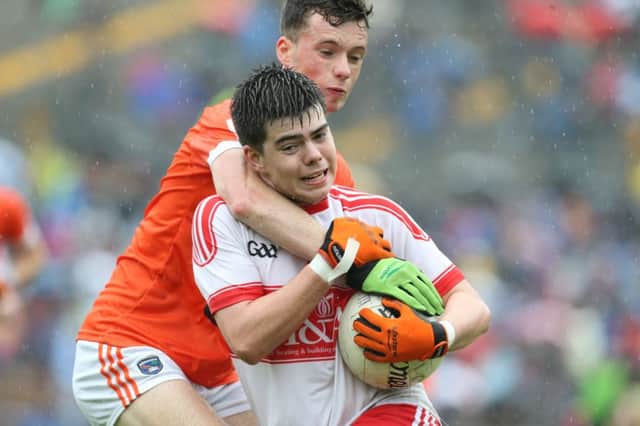 Derry's Simon McElain tries to break the tackle of Armagh's  Cathair McGeary of Armagh at Clones on Sunday. (Picture by Andrew Paton/Presseye.com)