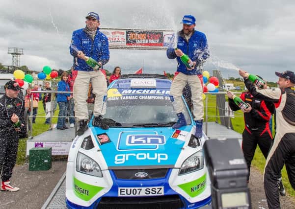 The 2015 Todds Leap Ulster Rally champions, Donagh Kelly and Kevin Flanagan celebrate their victory on top of their car as second and third places shower them with champagne. (Press Eye)