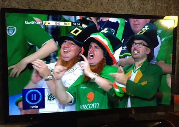 Martin Mullen (centre) pictured on TV during the Republic of Ireland's win over Italy in Lille. Included, from left is Redmond McFadden and Barry Mullen.