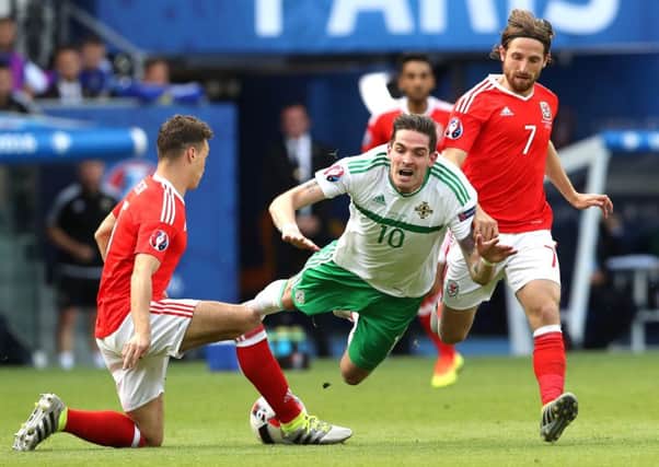 Northern Ireland's Kyle Lafferty is challenged by Wales' James Chester
