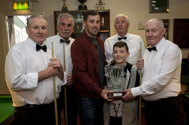 Mark and Ciaran Glackin present the Connie Glacking Annual Memorial Veterans Snooker Cup to Charlie O'Connell, captain, winners Cnoc Na Ros on Thursday night at the AOH, Foyle Street. Included from left are team members, Kevin McKinney, Joe Canning and Eugene Dunbar. DER2516MC020