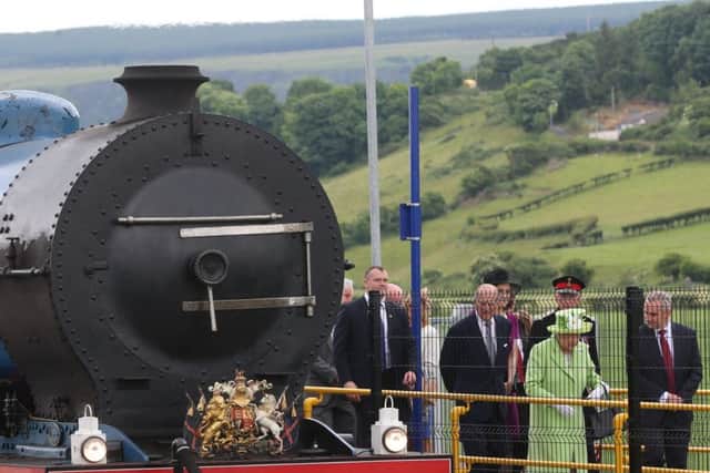 The Queen Elizabeth and the Duke of Edinburgh arrive at Bellarena railway station after travelling from Coleraine by steam train during the second day of her visit to Northern Ireland to mark her 90th birthday.