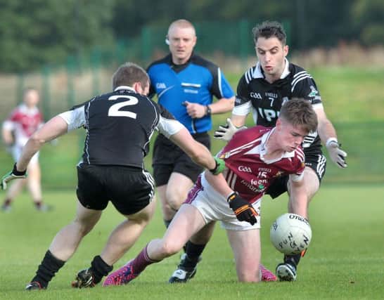 Dungiven's Martin McCloskey and Liam Hinphey hassle Conor Feeney of Banagher during last season senior Championship clash. This weekend's league clash is crucial for both clubs.