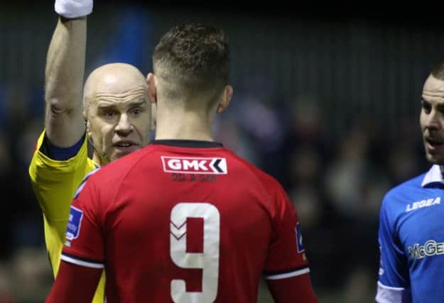 FRUSTRATION . .  Match referee Tomas Connolly books Derry's Jordan Allan during the opening match against Finn Harps.
