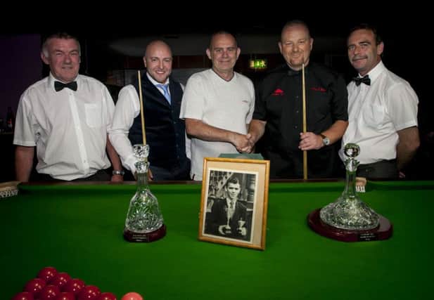 Keith Brady congratulates Gerald McCloskey on his victory in the 2016 renewal of the Hugh Brady (snr) North-West Senior Snooker Championship. Also included (from left)  Joe Sims (referee), Gareth Kirwan (runner-up) and Harry Logan (NWIABSA secretary). Framed photo of the late Hugh Brady in forefront.