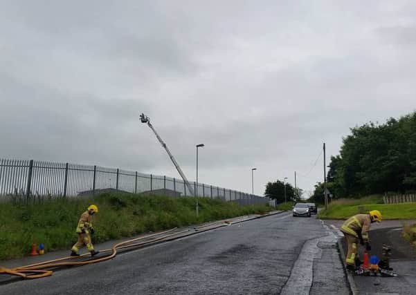 Fire fighters finishing up at Immaculate Conception - mindless arson which causes disruption and danger. The aerial appliance being used to avoid any asbestos danger to the crew. (Picture Martin Reilly)