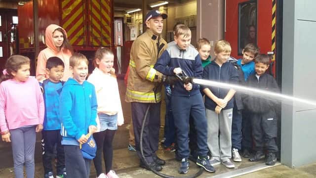Children from Belarus having fun as they are shown the ropes at Northland Road Fire Station.