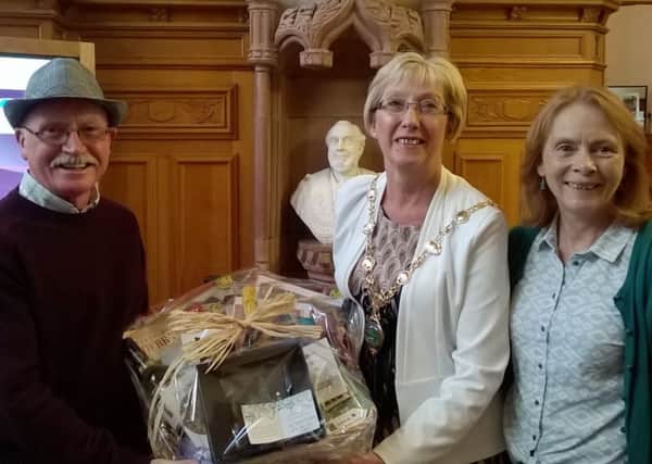 Mayor Ald. McClintock making a presentation to Kevin and Christine Keenan from Randalstown, the millionth visitors to the Guildhall.