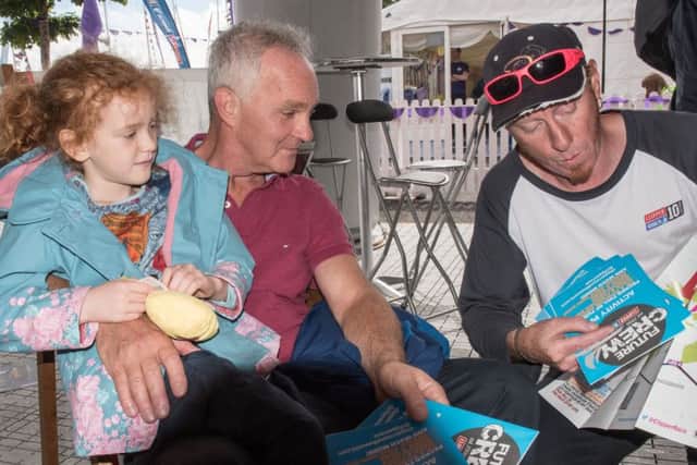 Shane McClure, right, who was a member of the 2012 Derry-Londonderry Clipper crew provides an insight into life on board a round the world yacht to Rose Marie Murry and her grandfather Bill Fulton. Picture Martin McKeown. Inpresspics.com. 09.07.16