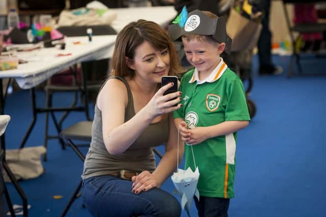 Four years-old Calum McCarron is shown a picture by his aunt Aisling McDonald during a visit to the STEM marquee at Saturday's Foyle Maritime Festival.