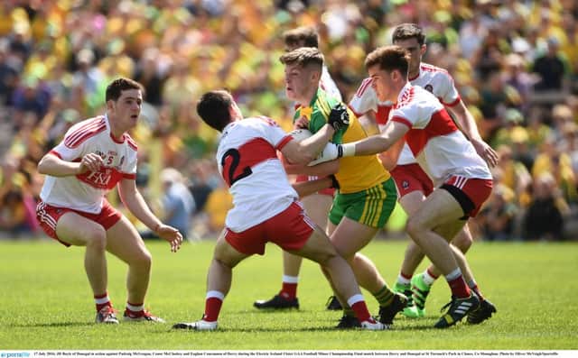 JD Boyle of Donegal in action against Padraig McGrogan, Conor McCluskey and Eoghan Concannon of Derry during the Electric Ireland Ulster GAA Football Minor Championship Final at St Tiernach's Park. (Photo by Oliver McVeigh/Sportsfile)