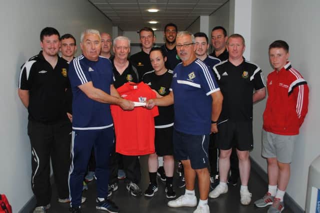 Ken Lowry receiving a cheque from Charlie Kelpie with referees from Northern Ireland, The Republic of Ireland, Scotland and England who are refereeing in this year's Foyle Cup. Photo: Gerry Morrison