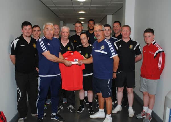 Ken Lowry receiving a cheque from Charlie Kelpie with referees from Northern Ireland, The Republic of Ireland, Scotland and England who are refereeing in this year's Foyle Cup. Photo: Gerry Morrison