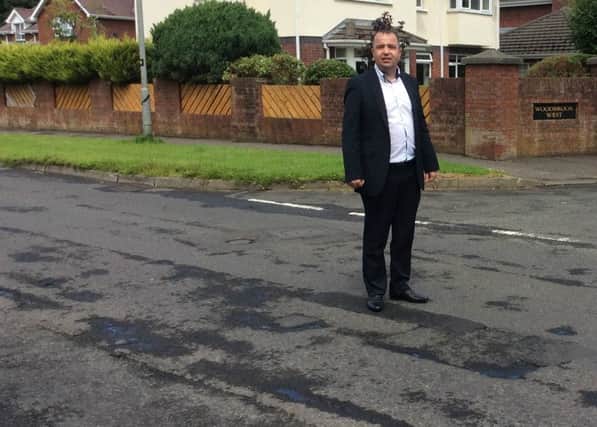 Brian Tierney pictured on the damaged road.