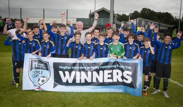 NO. 1 SUPPORTER!. . . . Deputy First Minister Martin McGuinness celebrates with his grandson and his Oxford United teammates after their victory in the Hughes Insurance Foyle Cup at St. Columb's Park, Derry on Wednesday evening. FC03-M1-08 (Photos: Jim McCafferty Photography)