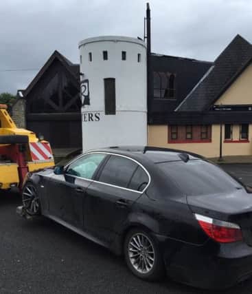 A car being towed away after the intervention of the PSNI yesterday.
