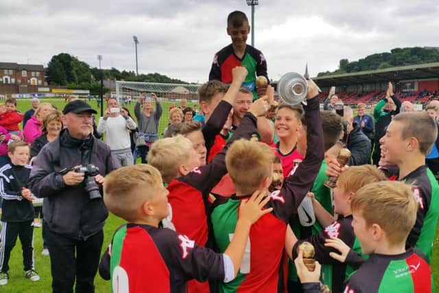 The Glentoran Under-12 side celebrate their 1-0 win over Donegal Schoolboys in the U12 showpiece at Brandywell.