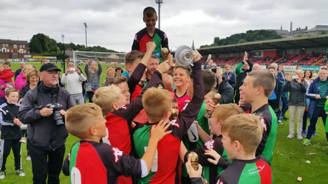 The Glentoran Under-12 side celebrate their 1-0 win over Donegal Schoolboys in the U12 showpiece at Brandywell.