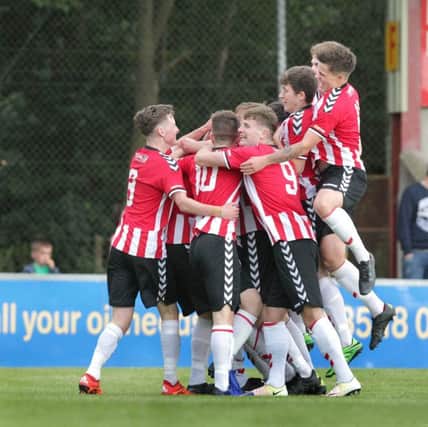 Derry City celebrate their first goal against Trojans during the Foyle Cup under 17 Final at the Riverside Stadium in Derry on Friday night. Picture BY Margaret McLaughlin.