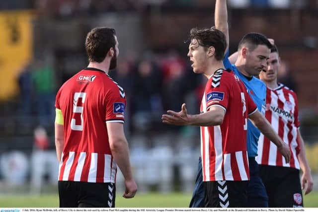 Ryan McBride, left, of Derry City is shown the red card by referee Paul McLaughlin during the SSE Airtricity League Premier Division match between Derry City and Dundalk.