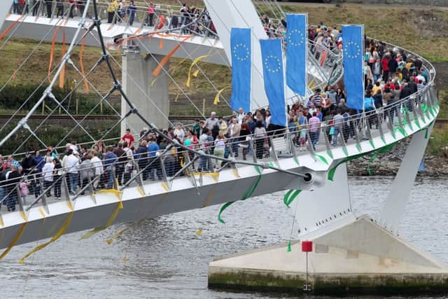 People crossing the European Union funded Peace Bridge on the day it was opened by the EU Commissioner for Regional Policy Johannes Hahn back in June 2011. Picture: Michael Cooper