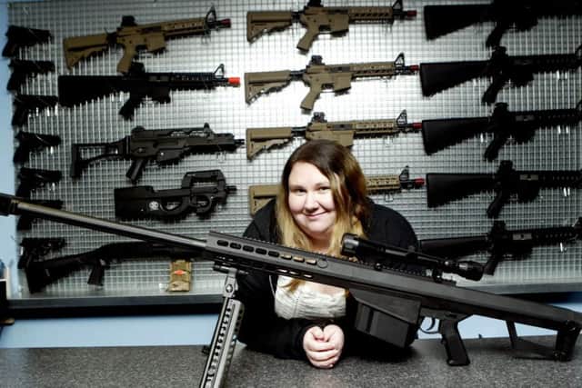 Caroline pictured with an array of the Airsoft guns used at Predator Zone.