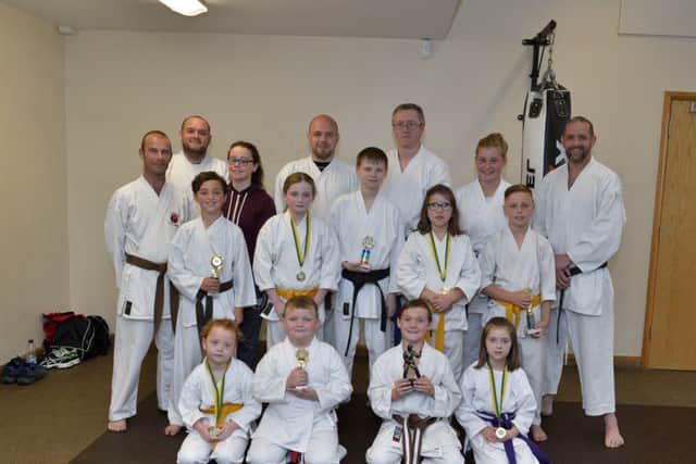 Junior members of the Fudoshinn Shotokan Kartate Club at the Vale Centre Greysteel pictured with medals and trophies won at the annual awards presentation on Wednesday evening last. Included in the photo are senior members of the club and club instructor Don Geddis 2nd Dan (back row, left). DER3016GS033