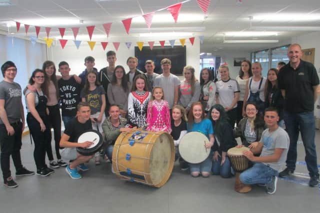 Young people pictured during a practice session with Alan Warke of Different Skins and a performance of Irish dancing.