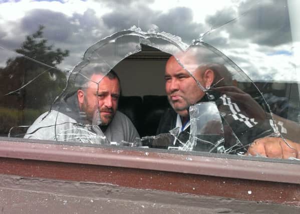 Independent Councillor Gary Donnelly and Sean McIntyre survey the damage to Mrs McIntyre's home in Rinmore Drive.