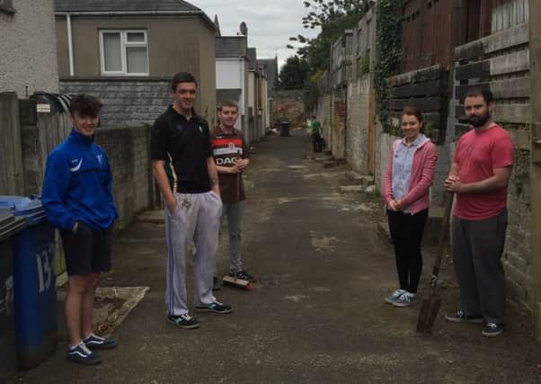 Ogra Shinn FÃ©in members in Derry who helped in the clean-up in the lanes between homes on the Lonemoor Road and Jacqueline Way.