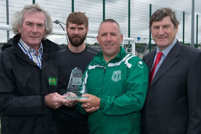 McDonald's Head of Northern Ireland Football Pat Jennings, Paddy McCourt and McDonald's Crescent Link franchisee David Walker present Leroy McCourt with the McDonald's Regional Coach of the Year Award.