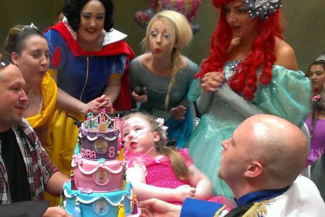 Cora McQuade Denvir (centre) celebrates her birthday with parents Amy and Ciaran (right) and Disney Princesses Snow White, Elsa and Ariel. INLT-32-709-con