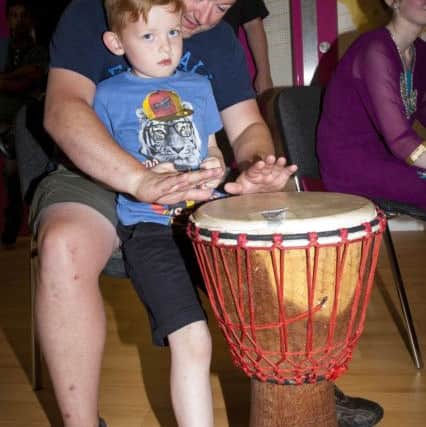 DRUMMING PRACTICE. . . . .Gerard O'Kane and his son Cathair (6) get in some drumming during Friday night's 'Celebrating Diversity and Friendship' Multicultural Evening at the new Studio 2 in Skeoge.