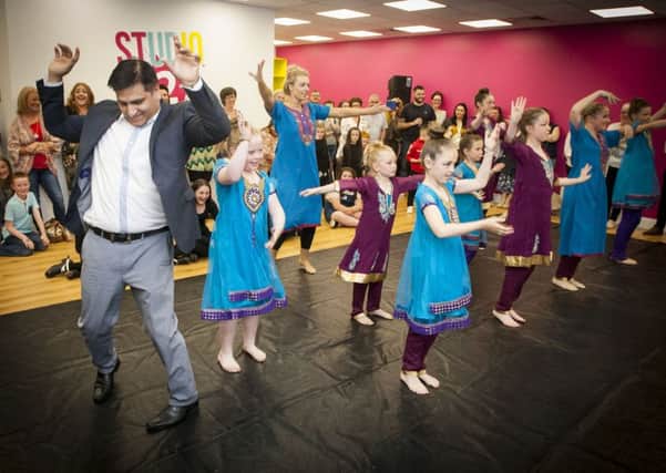 Dr. Mukesh Chugh joins in on the dance routine with Irena Noonan and her Streetfeet dancers during Friday night's 'Celebrating Diversity and Friendship' Multicultural Evening at the new Studio 2 in Skeoge.