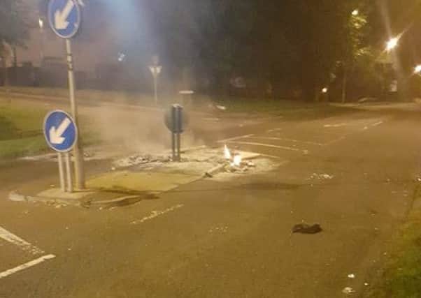 Debris torched at the traffic island.