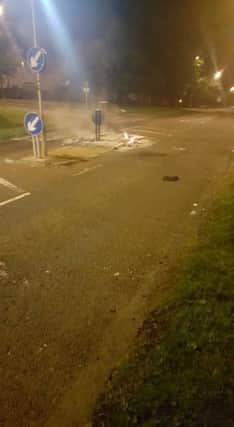Debris torched at the traffic island.