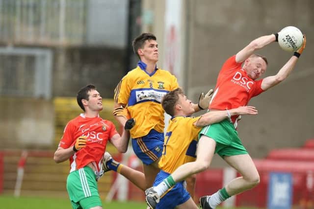 Drum's Kevin O'Reilly makes an excellent catch despite pressure from Limavady duo Liam O'Kane and  Kack Deery in Sunday's Junior Championship match in Celtic Park. (Photo: Dessie Loughery)