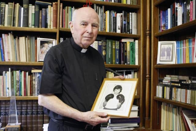 Bishop Edward Daly pictured in 2010 holding a portrait of Jackie Duddy. (Photo: Niall Carson/PA Wire)
