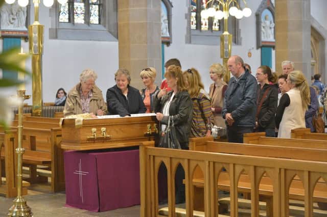 Parishioners pay their respects to the late retired Bishop of Derry, Dr Edward Daly, at St. Eugene's Cathedral on Tuesday afternoon. DER3216GS25. Photo George Sweeney.