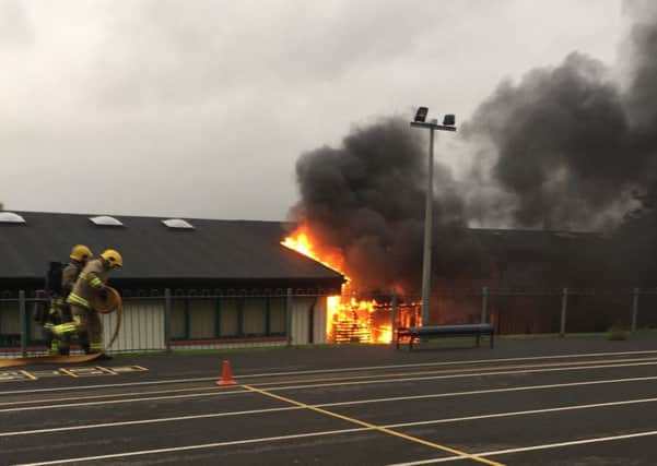 Firefighters tackle the fire at Good Shepherd Primary School.
