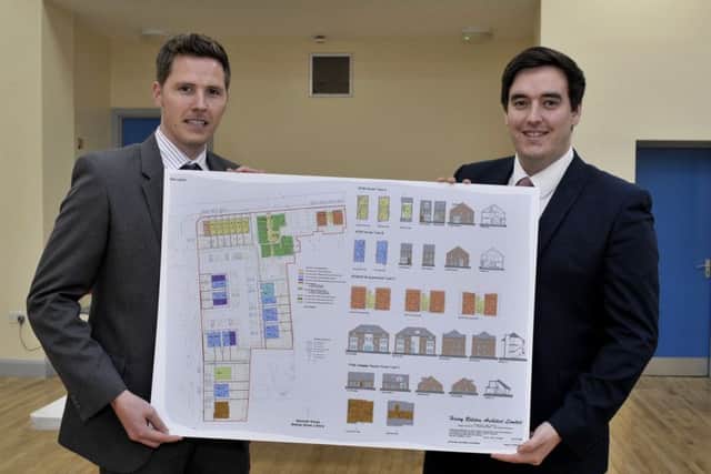 Lee Harrigan (left) Planning Consultant with Belfast developers CEP Planning Limited and architect Matt Bishop display plans for the proposed redevelopment of Nazareth House, at a public meeting in the Bishop Street Community Centre on Wednesday afternoon. DER3216GS042