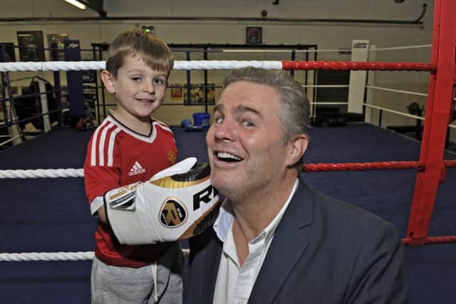 4 year-old Shea Quigley from Creggan pictured with IBF world cruiser weight champion Glen McCrory  at the official opening of Oak Leaf Boxing Clubs new facilities at Rath Mor Business Park on Wednesday night.  DER3216GS048