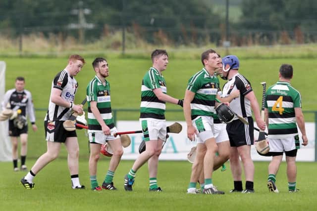Na Magha players leave the pitch after a heavy defeat to Kevin Lynch's in the Derry SHC quarter final match at Owenbeg on Sunday night. (Picture Margaret McLaughlin)