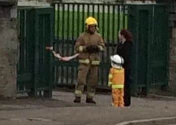 Caiden speaking to a local fireman at the scene of the fire in the Waterside last week.