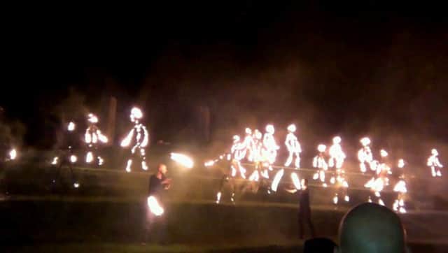 Two fire artists pictured in front of the Children of Fire at the Gasyard Feile Finale.
