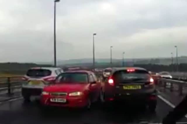 An image taken from the video which clearly shows a car being driven on the wrong side of the Foyle Bridge in Derry.