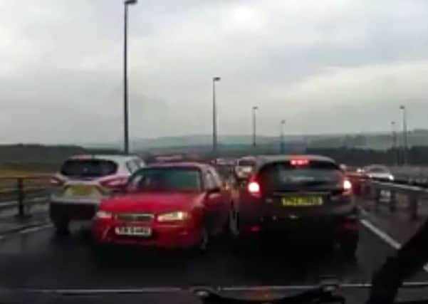 An image taken from the video which clearly shows a car being driven on the wrong side of the Foyle Bridge in Derry.